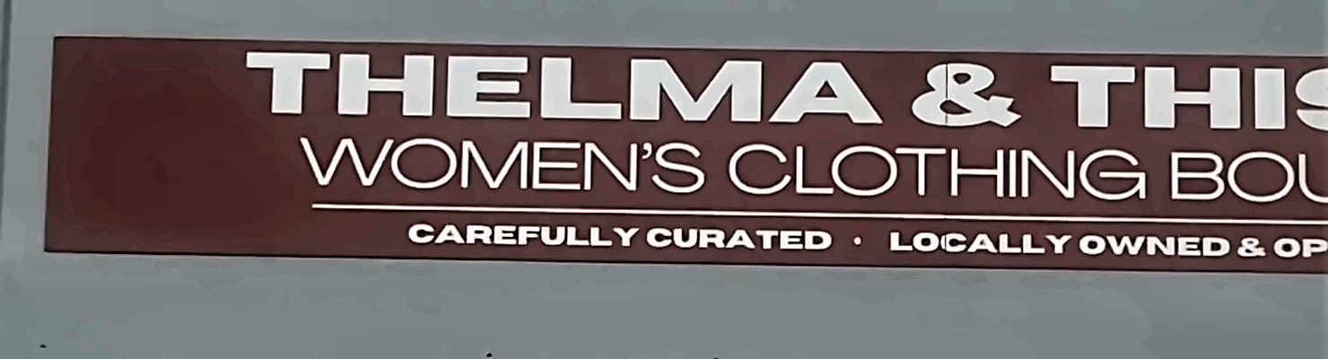 Thelma and Thistle sign on the Foundry facade: women's clothing boutique, carefully curated, locally owned